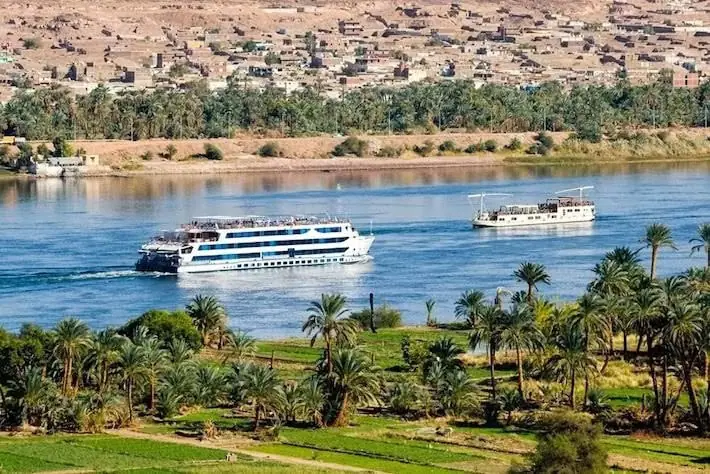 Cruise ship and traditional dahabiya sailing on the Nile River, Luxor