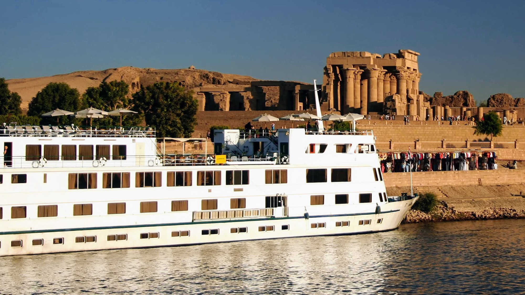 Kom Ombo Temple ruins with Nile River cruise ship and tourists