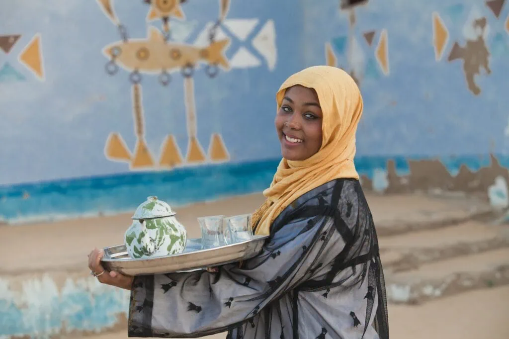 A Nubian girl carrying a teapot, Aswan