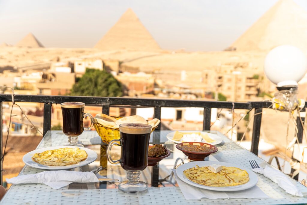 A table in an outdoor restaurant with a fantastically beautiful view of the great pyramids of Giza. Cairo. Egypt. Romantic dinner food