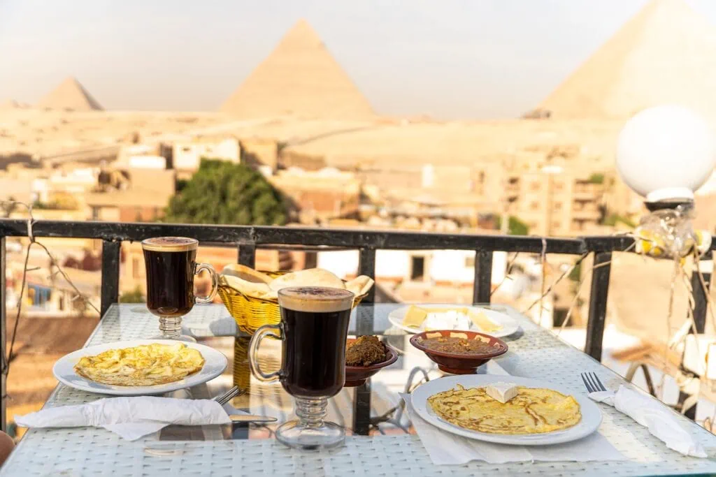 A table in an outdoor restaurant with a fantastically beautiful view of the great pyramids of Giza. Cairo. Egypt. Romantic dinner food