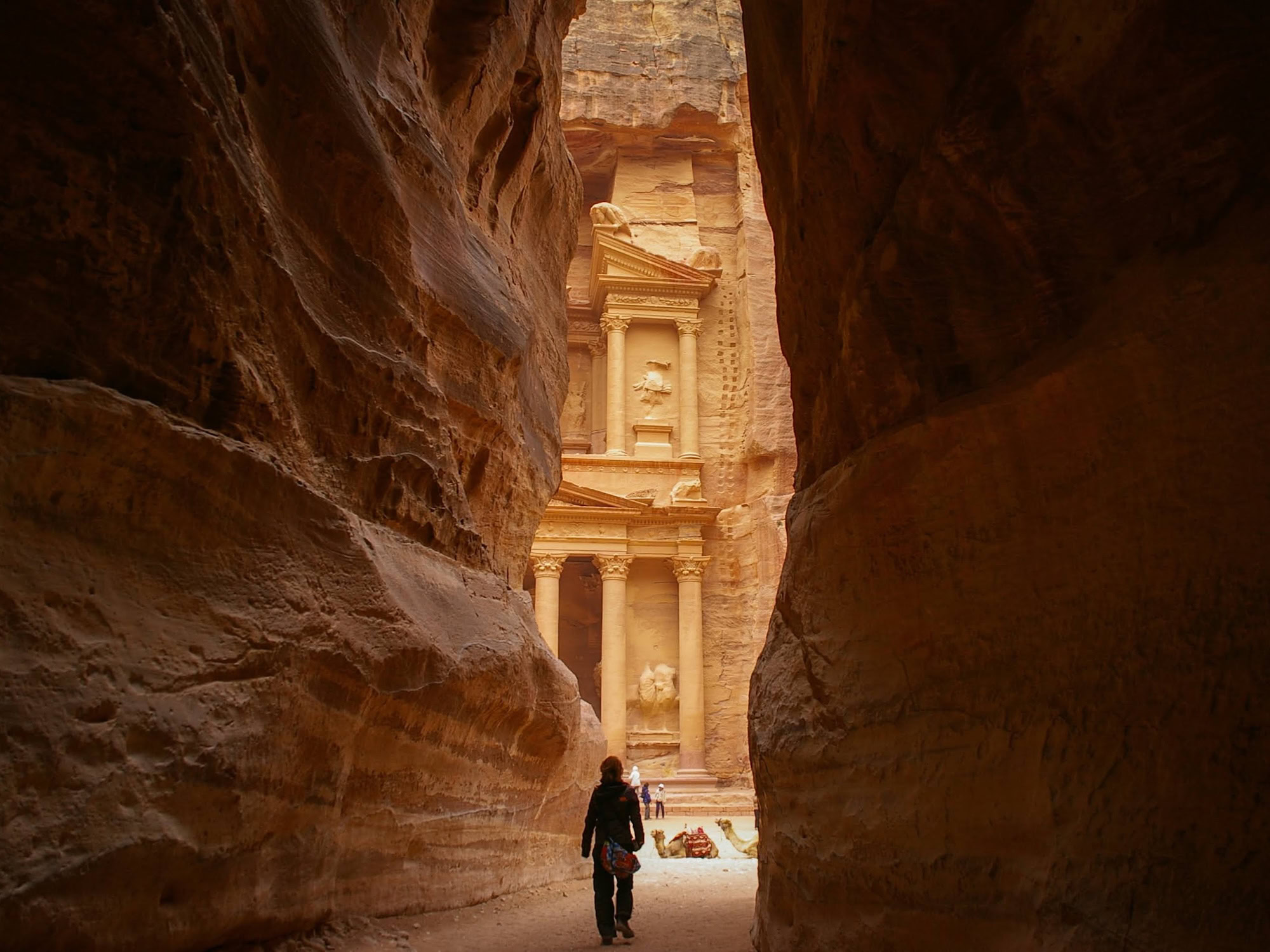 The Treasury facade carved into red sandstone canyon walls at Petra, Jordan