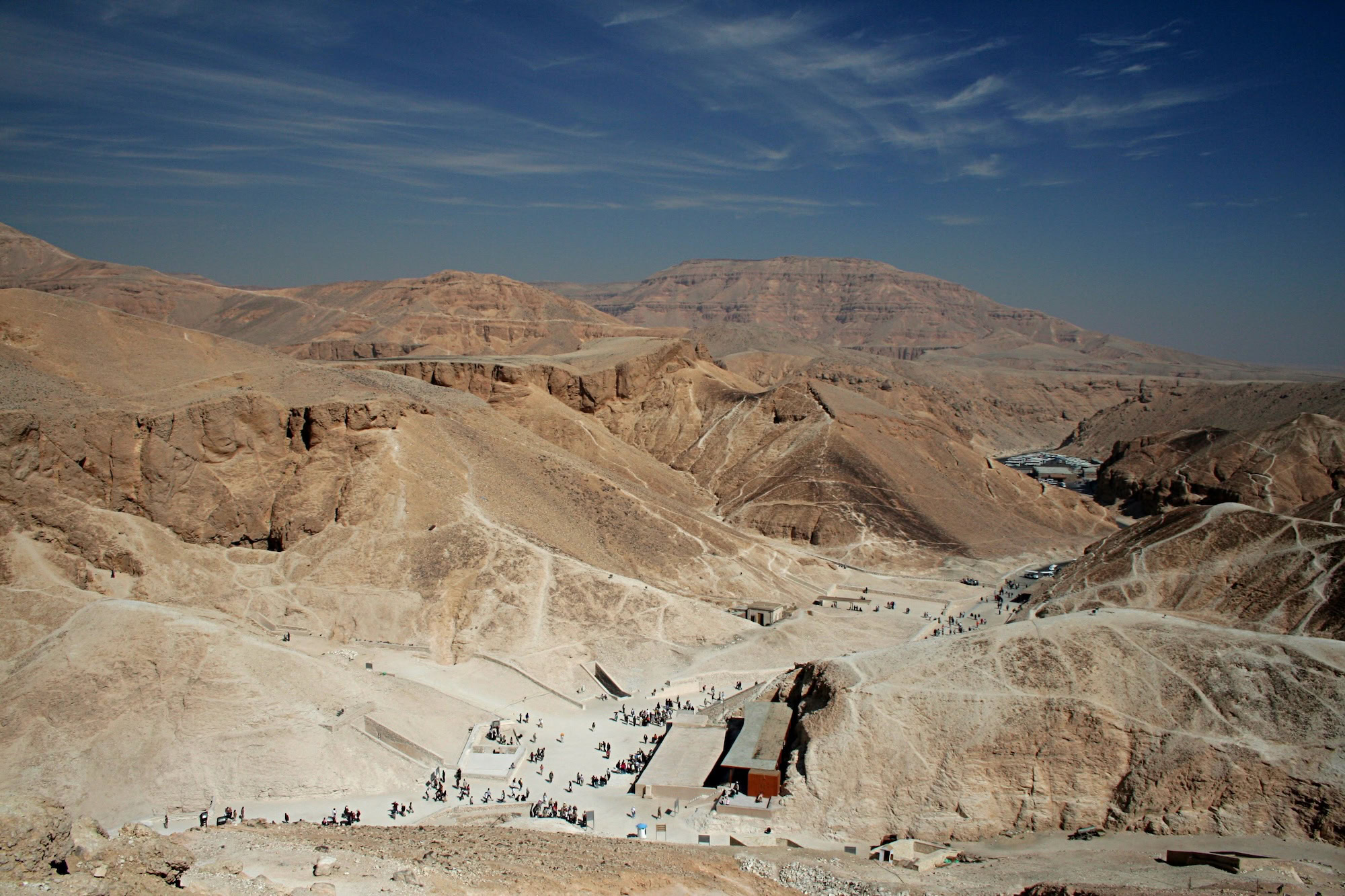 Panoramic view of Valley of the Kings archaeological site in Luxor, Egypt with tourists exploring