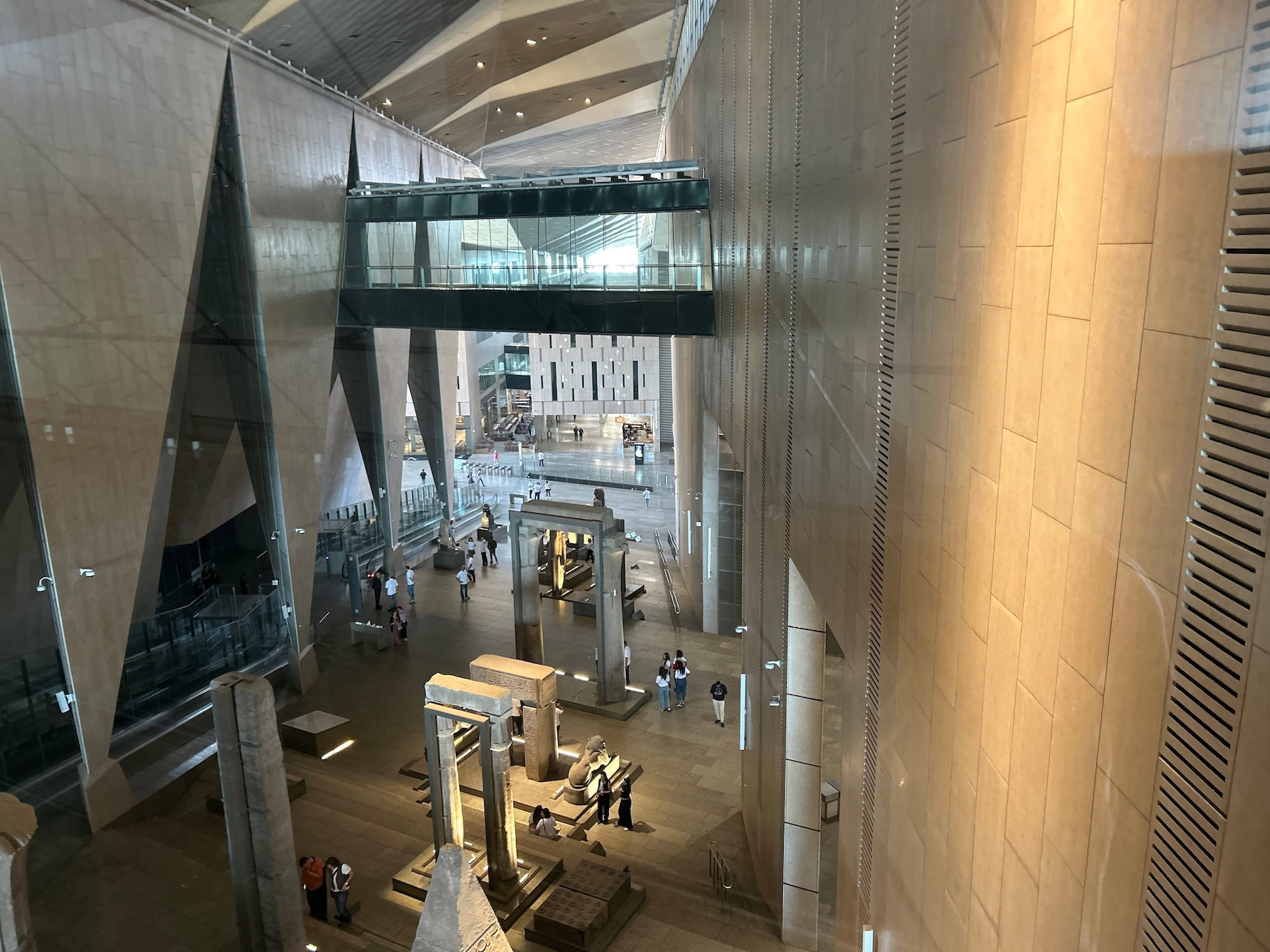 Interior view of Grand Egyptian Museum displaying ancient Egyptian artifacts and stone columns