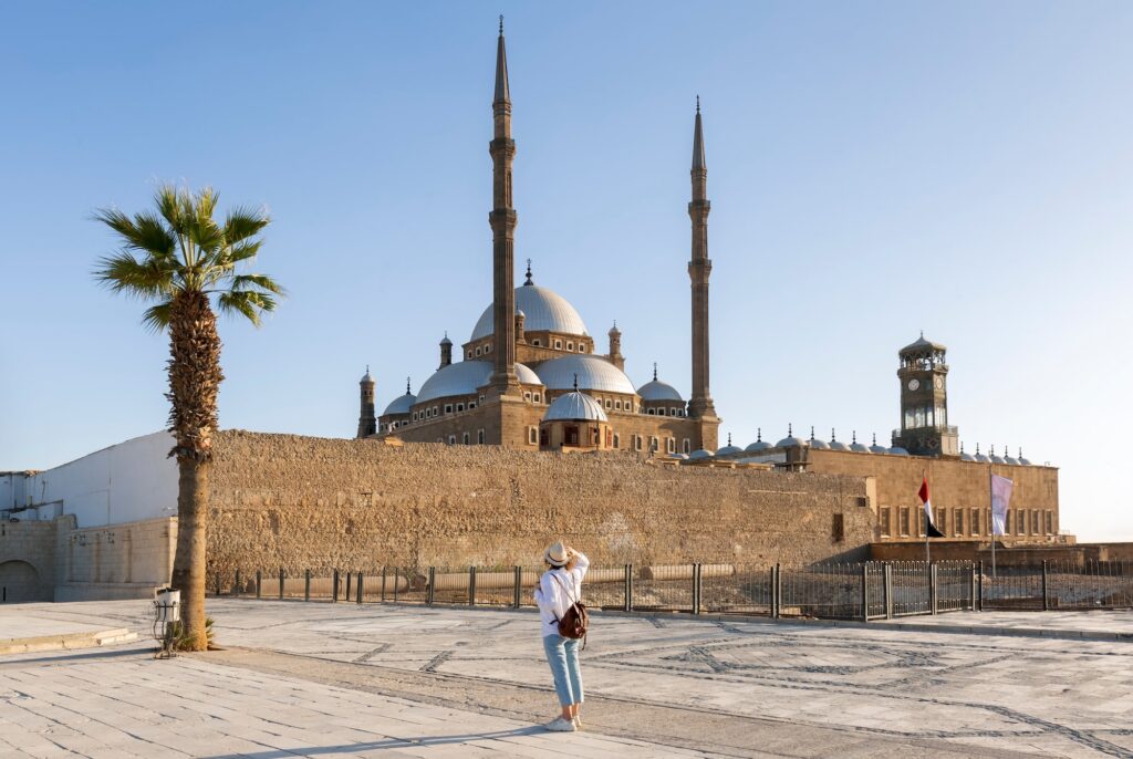 A woman walking near the stone defensive walls of the Cairo Citadel, Cairo