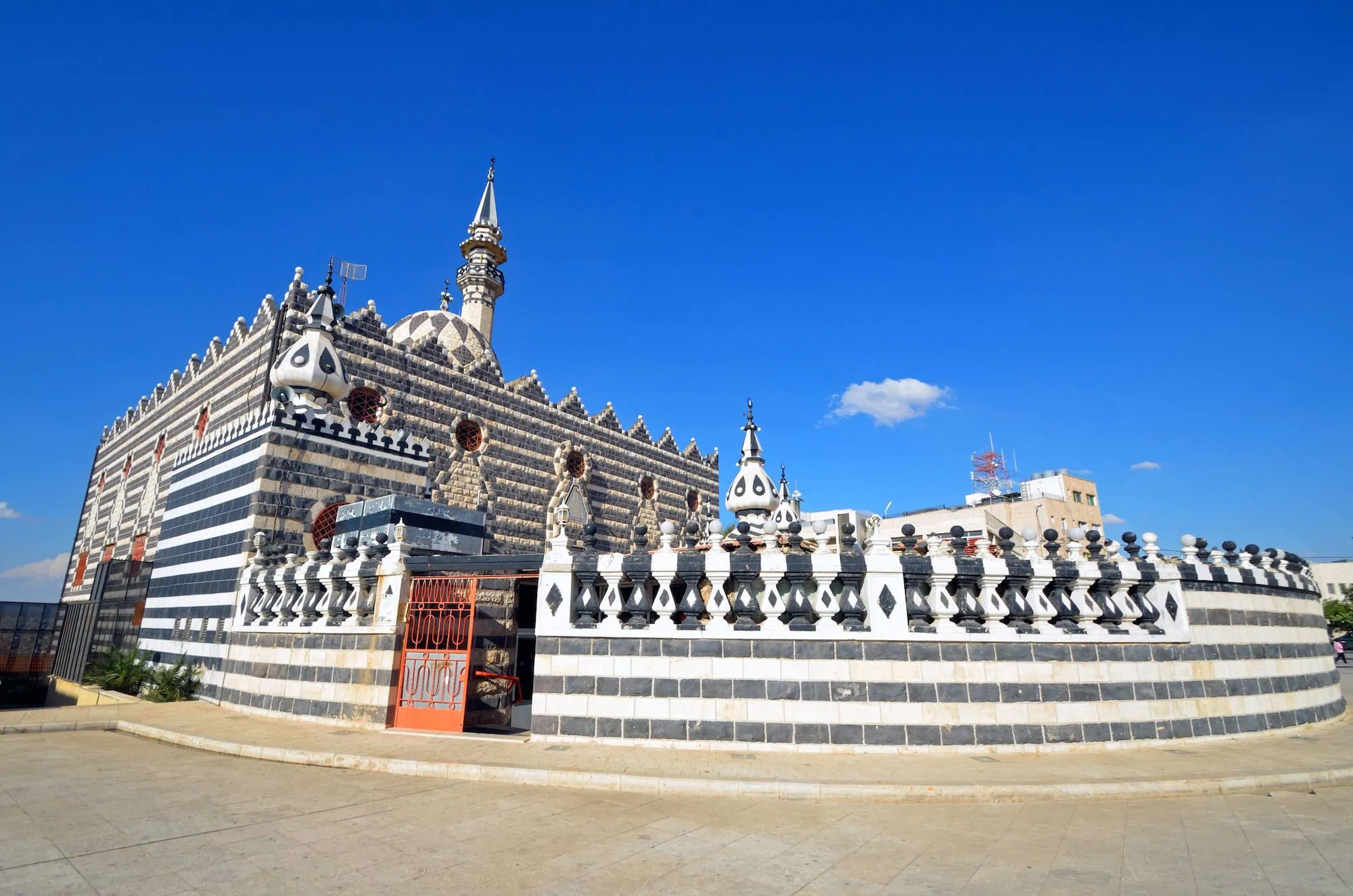Abu Darwish Mosque with distinctive black and white striped architecture and geometric patterns