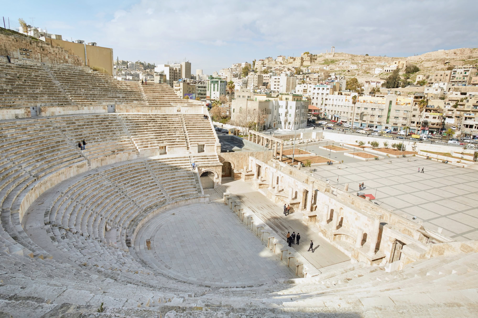 Ancient Roman amphitheater with stone columns and seating tiers in Amman