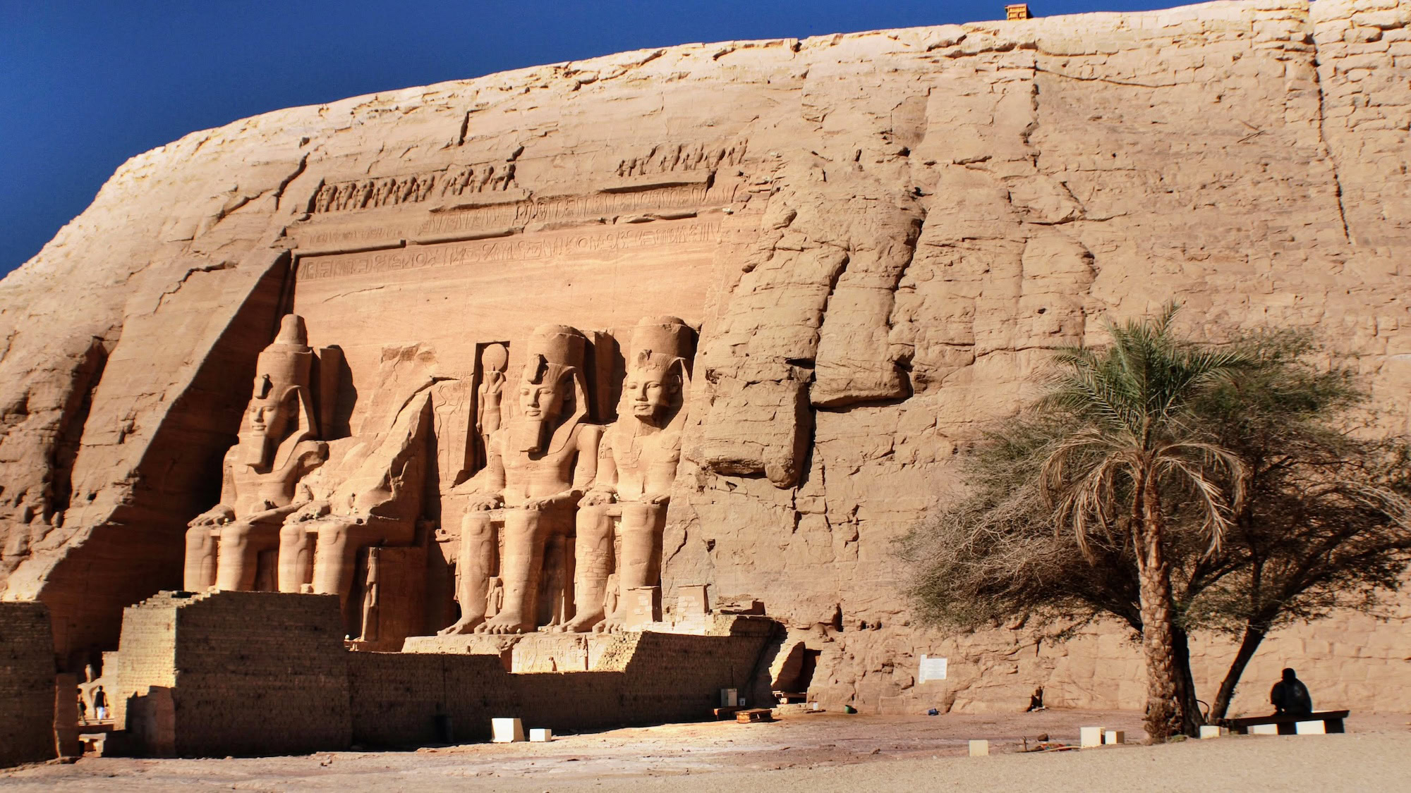 Majestic Abu Simbel temples with colossal pharaoh statues carved into sandstone cliff face