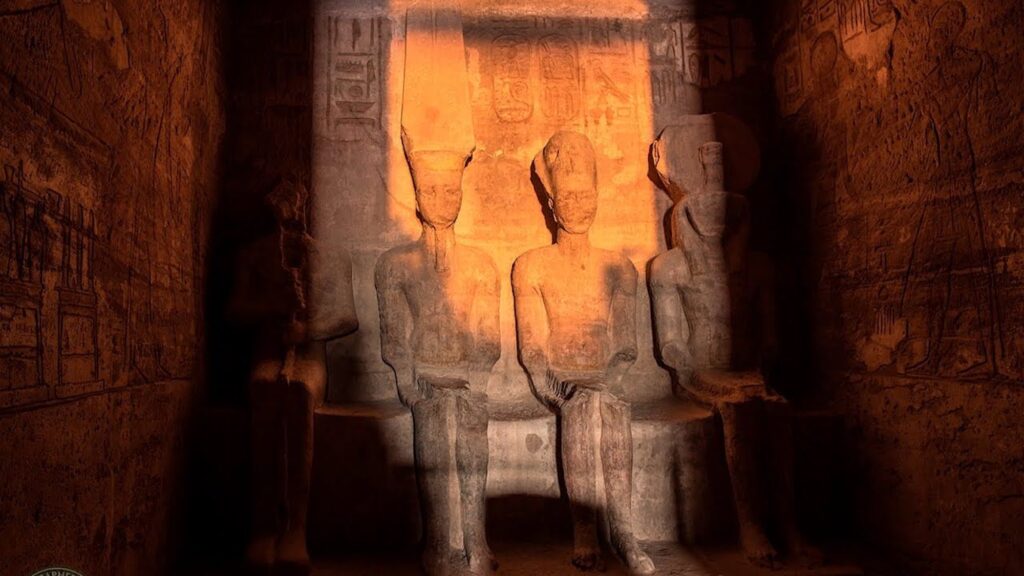 Sunlight beam illuminating carved statues during the Abu Simbel Sun Festival