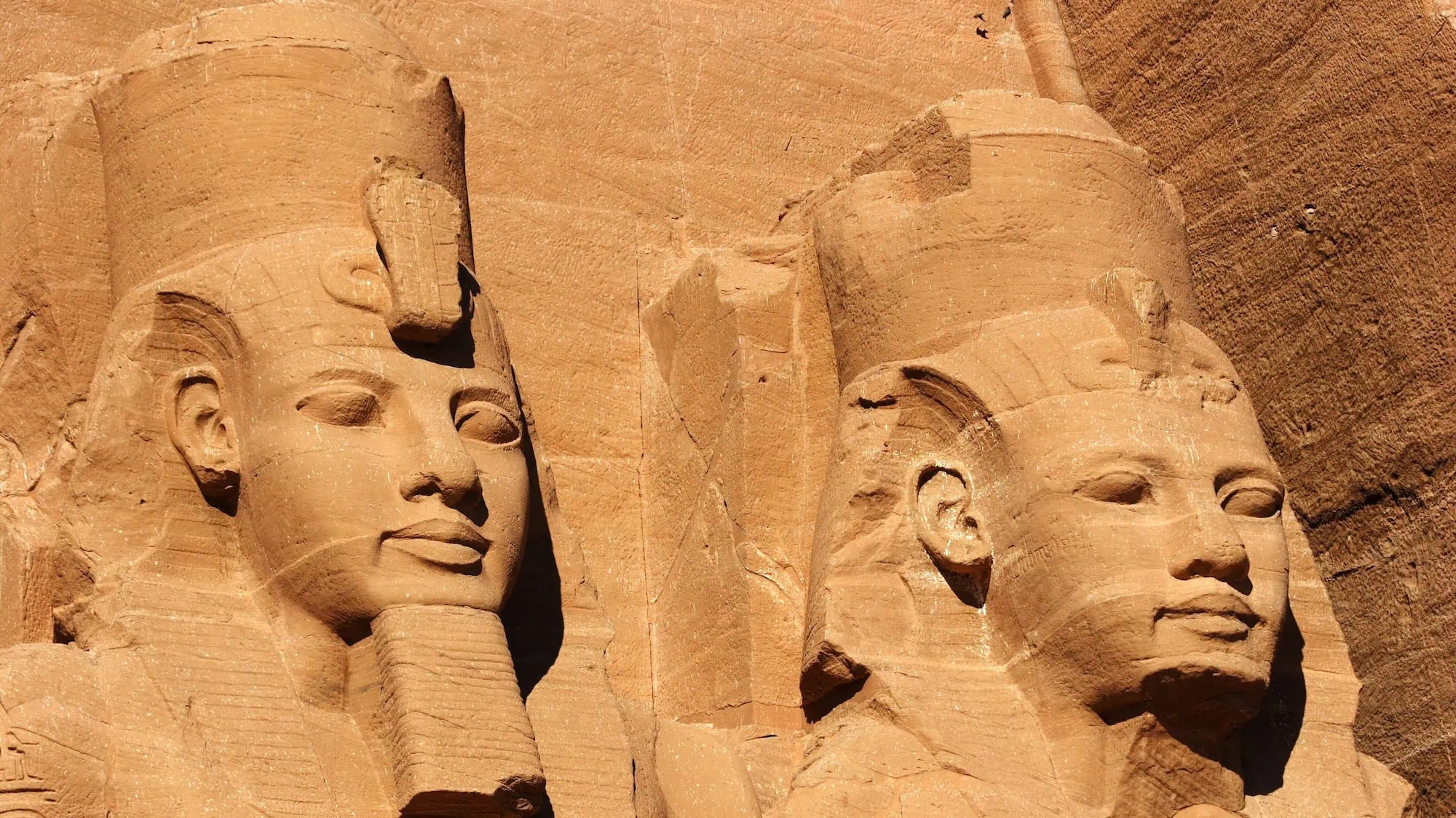 Colossal pharaoh statues carved in sandstone at Abu Simbel temple
