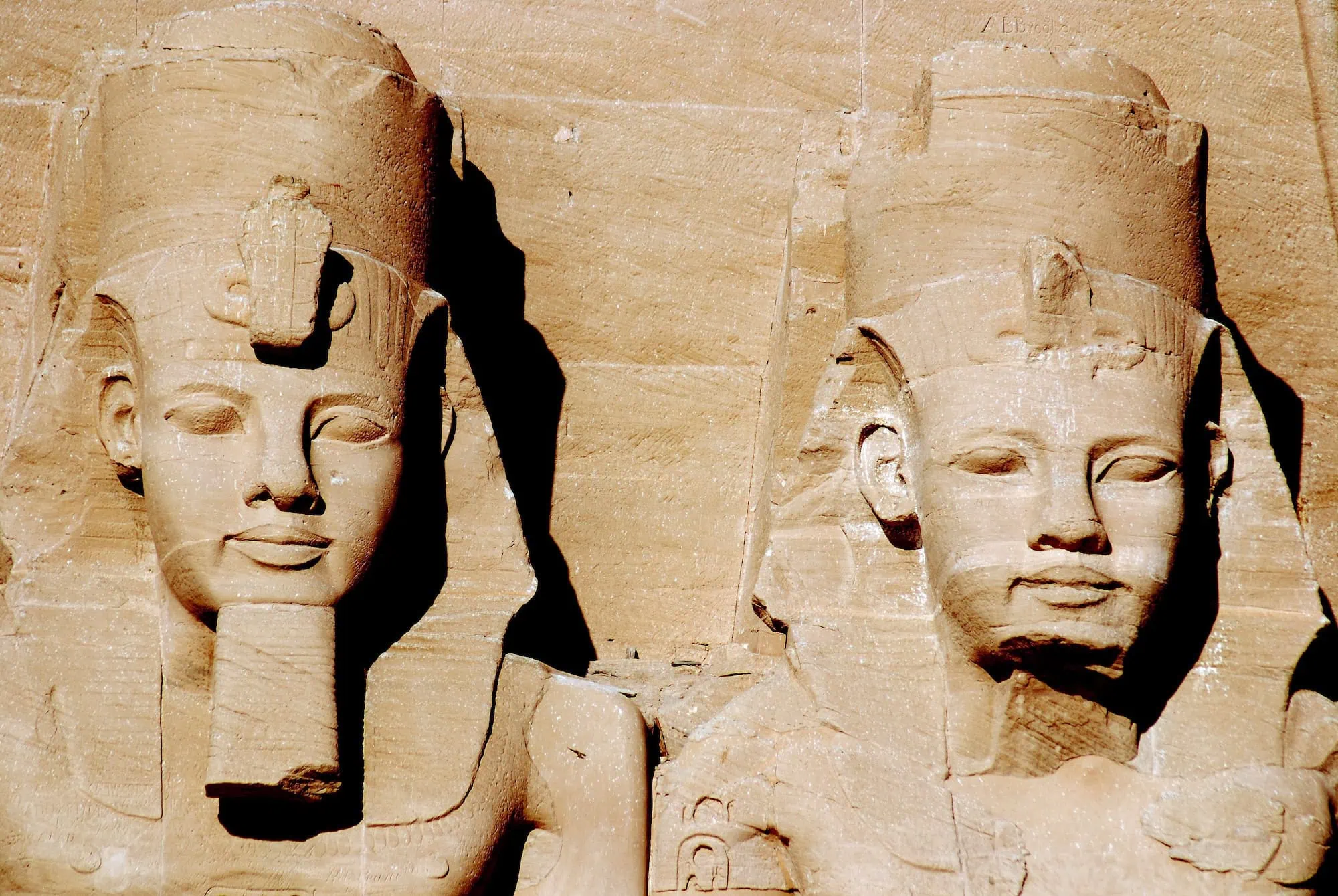 Colossal statues of pharaohs carved into rock at Abu Simbel temples