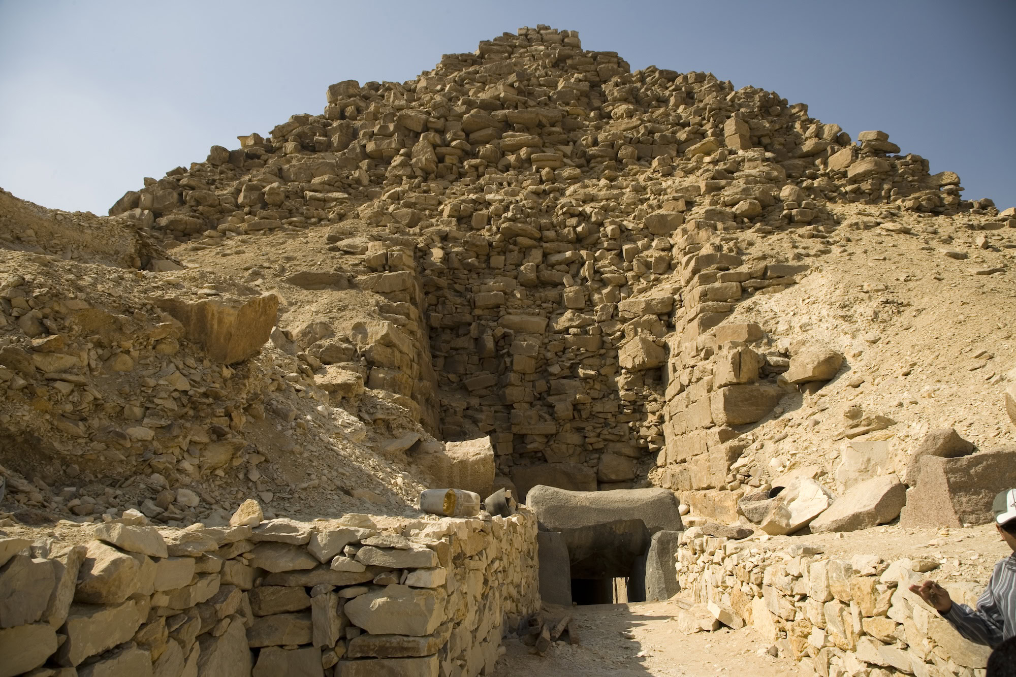 Rovine di piramide antica danneggiata con blocchi di pietra e sabbia del deserto