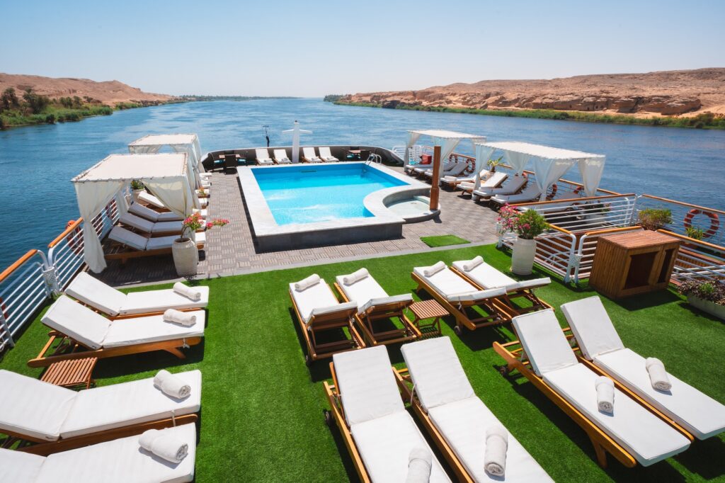 Swimming pool on the sun deck of a Nile cruise ship overlooking the Nile River, Luxor