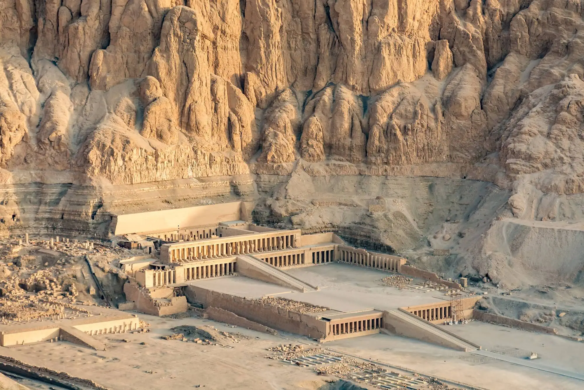 Aerial view of Hatshepsut Temple built into limestone cliffs at Deir el-Bahari, showing terraced architecture