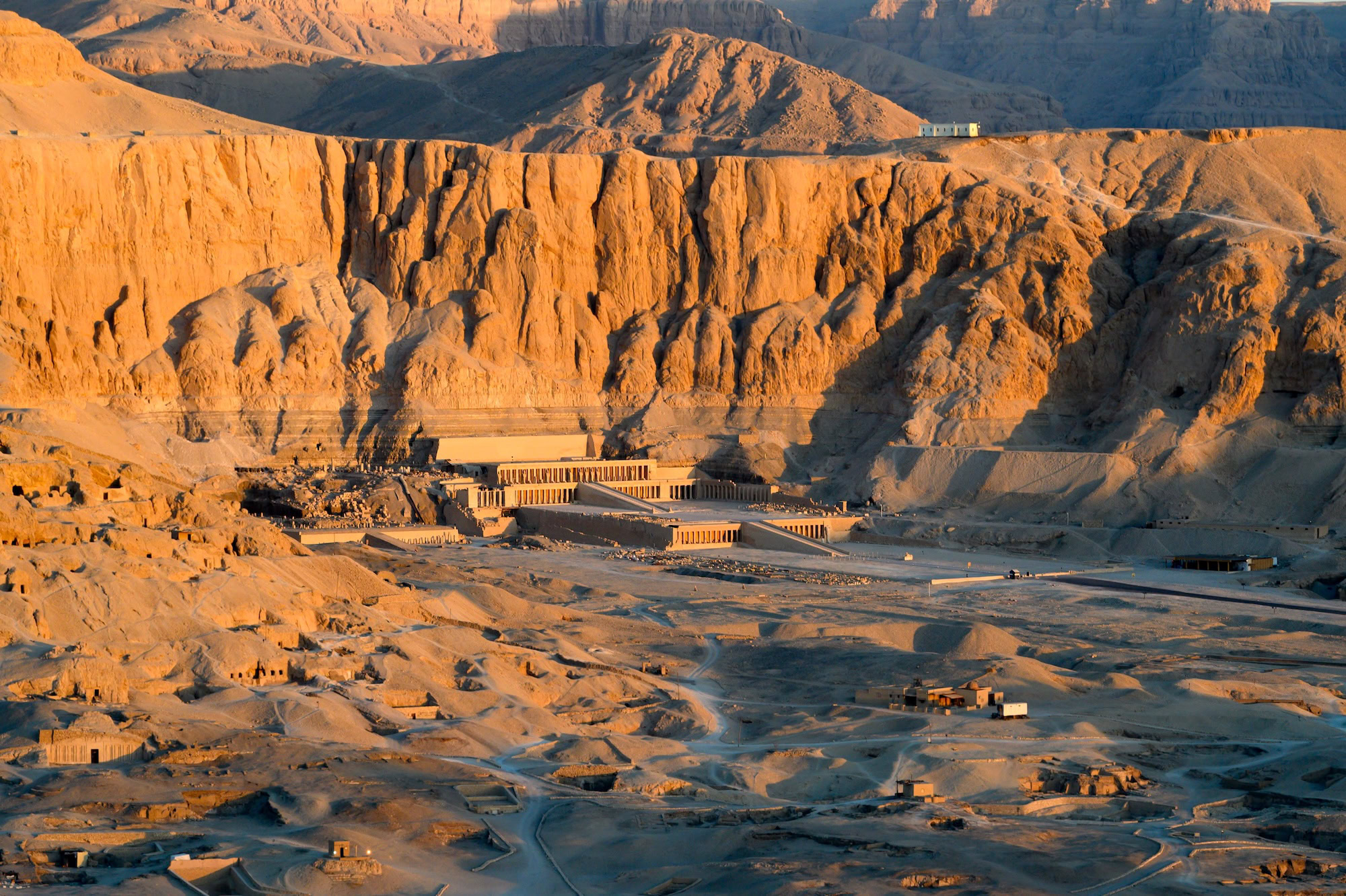 Aerial view of Hatshepsut Temple at sunrise in Luxor, Egypt – a highlight of Egypt tours from NYC, nestled beneath red cliffs on the Nile’s west bank in the Valley of the Kings.