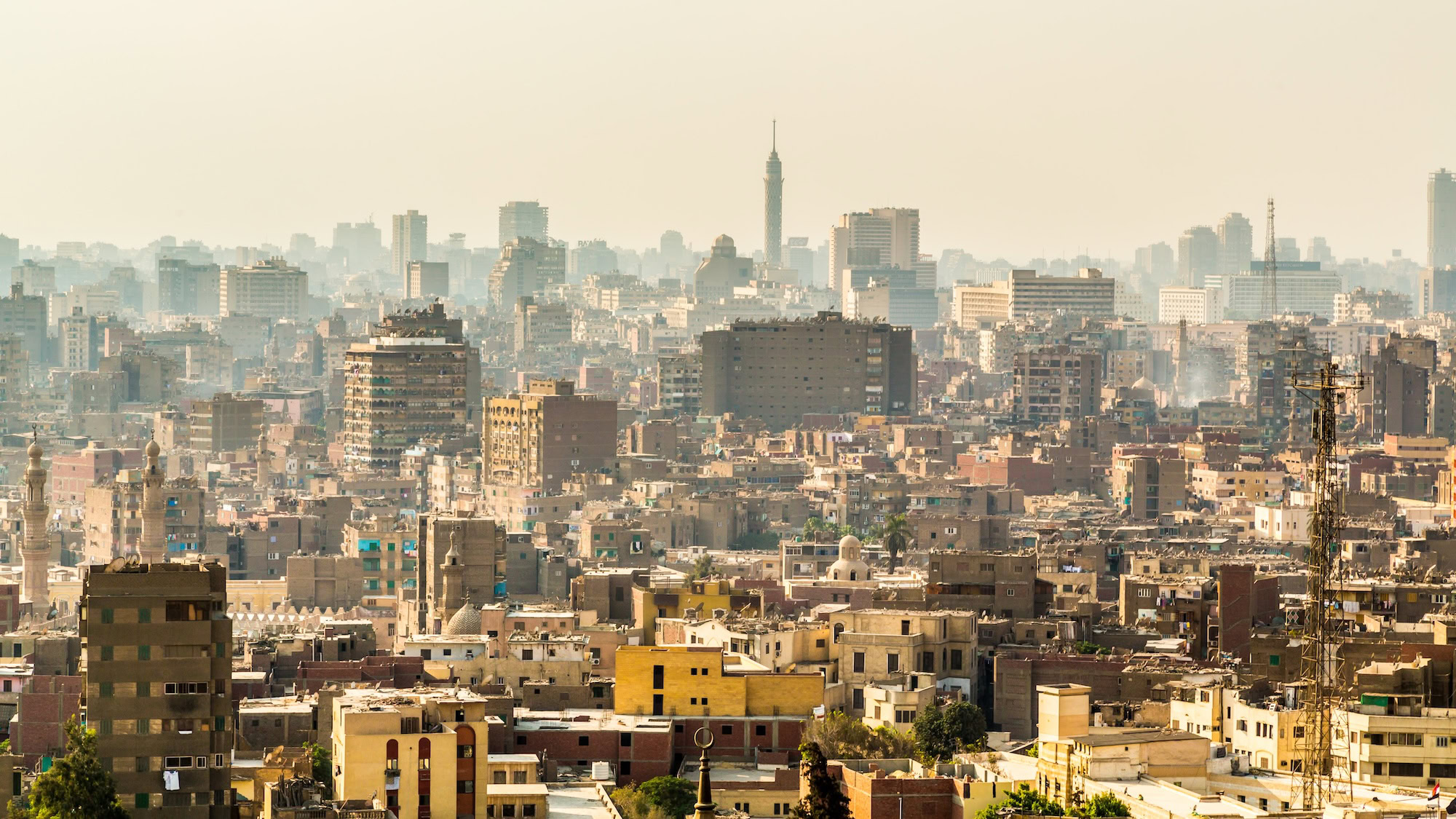 Cairo cityscape showing dense urban development with modern skyscrapers and Cairo Tower