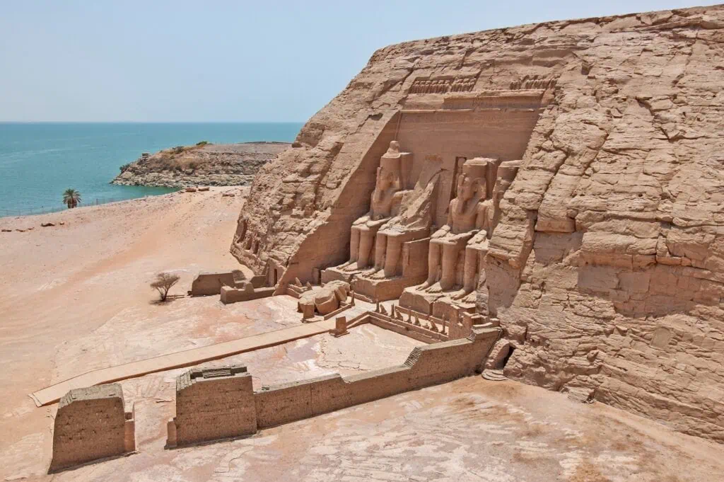 Aerial view of the exterior entrance to the Temple of Ramses II with colossal seated statues and Lake Nasser in the background, Abu Simbel