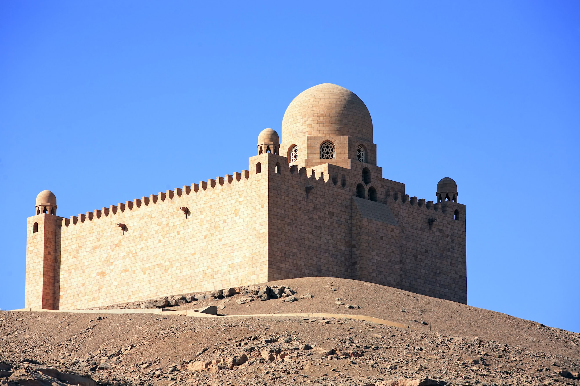 Aga Khan Mausoleum with distinctive dome and fortress-like walls on desert hill