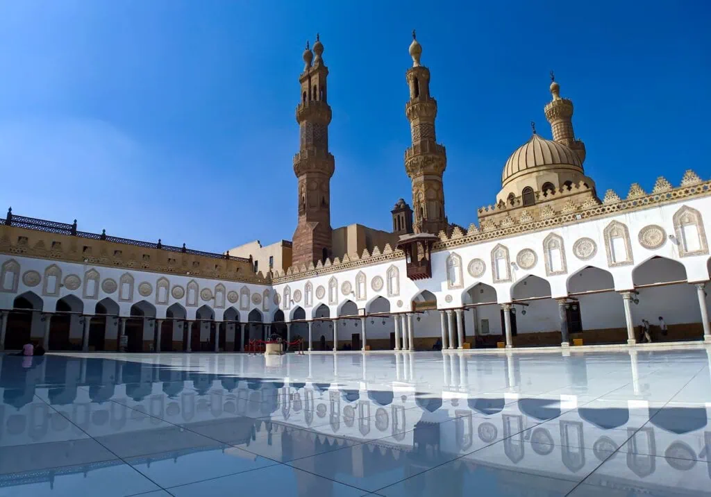 An interior courtyard with arcades, marble flooring, and surrounding minarets at Al-Azhar Mosque