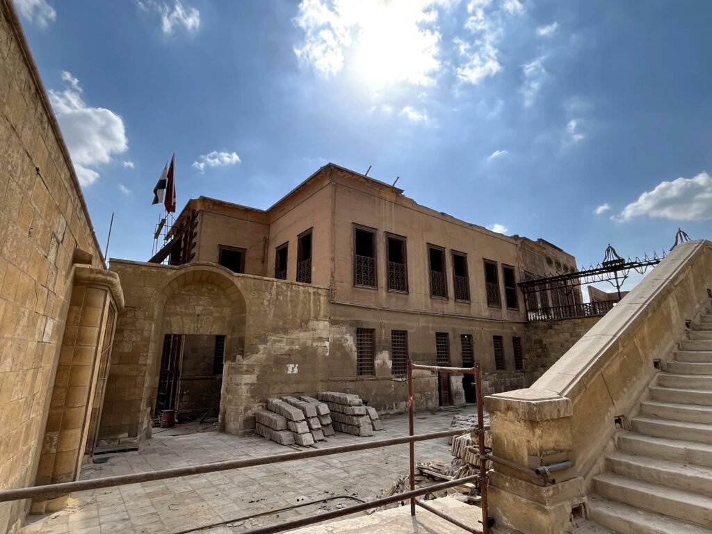 Courtyard view of Al Gawhara Palace showing stone walls, stairway, and surrounding façades within the Citadel, Cairo