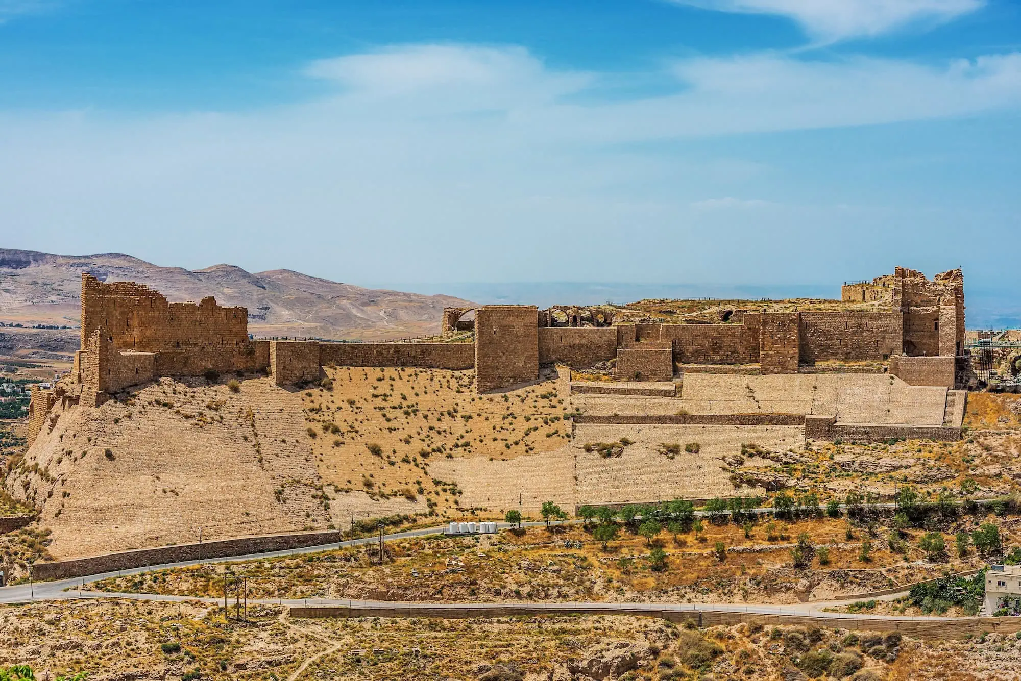 Al-Karak Castle fortress complex positioned on elevated terrain in Jordan's arid landscape