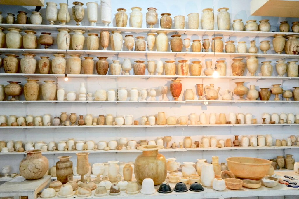 Alabaster vases and bowls displayed on shelves inside a local handicraft shop, Luxor