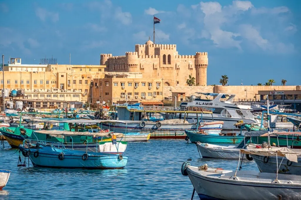 Waterfront view of the historic stone walls and towers of the Citadel of Qaitbay, Alexandria