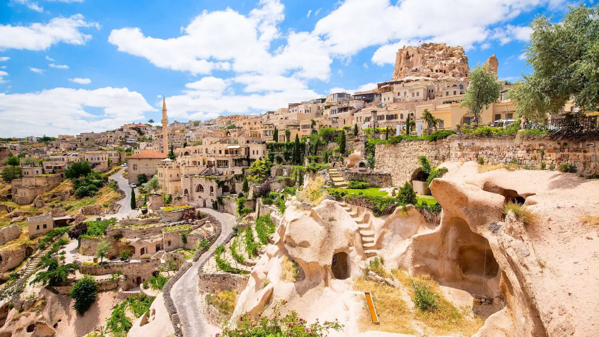 Historic Uchisar Castle with carved cave dwellings and stone buildings in Cappadocia