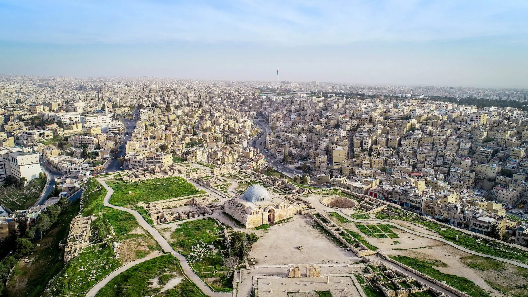Aerial view of Amman Citadel ruins showing ancient foundations and strategic hilltop location overlooking modern Amman