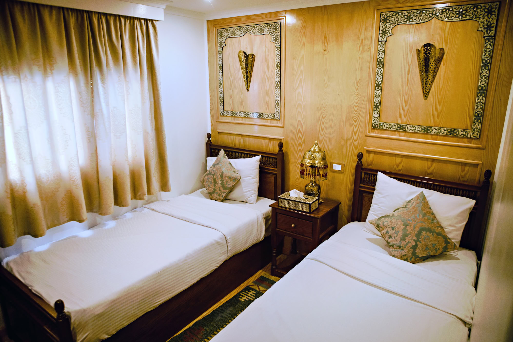 Luxurious twin bedroom interior with traditional Egyptian decor and ornate furnishings