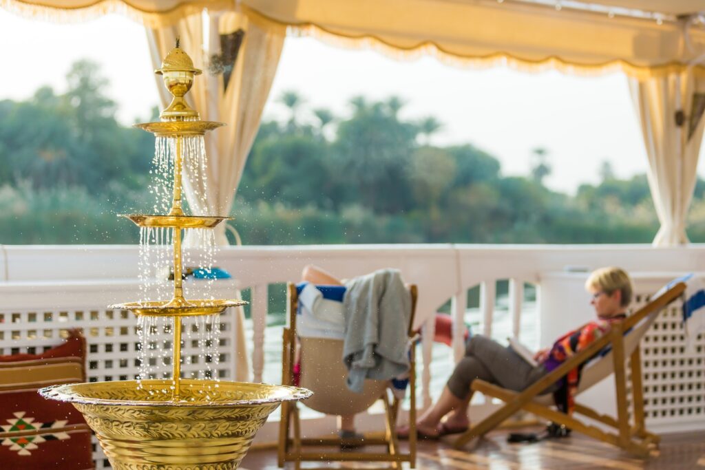 Outdoor lounge seating on MS Amoura Dahabiya overlooking the Nile, Luxor