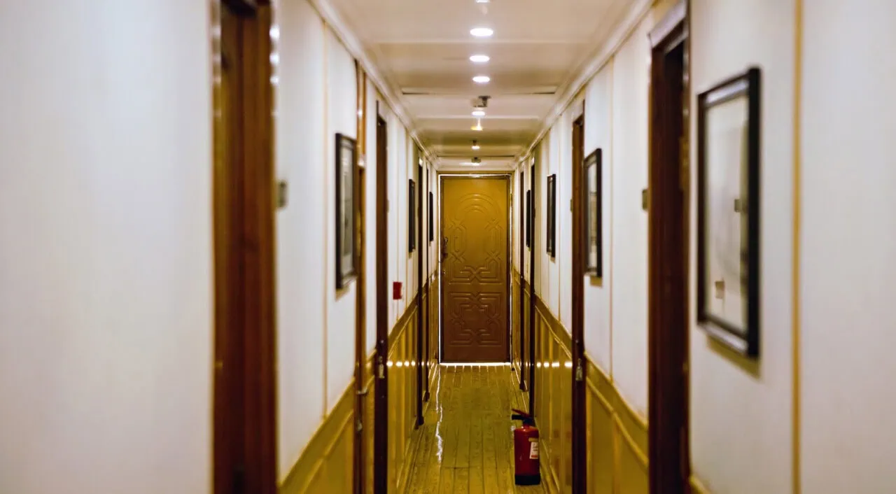 Wooden hallway on MS Amoura Dahabiya with warm lighting