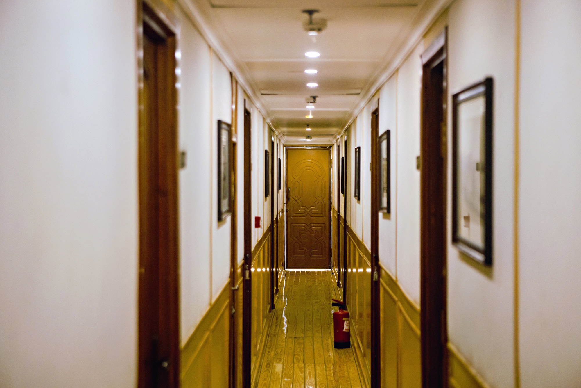 Wooden hallway on MS Amoura Dahabiya with warm lighting