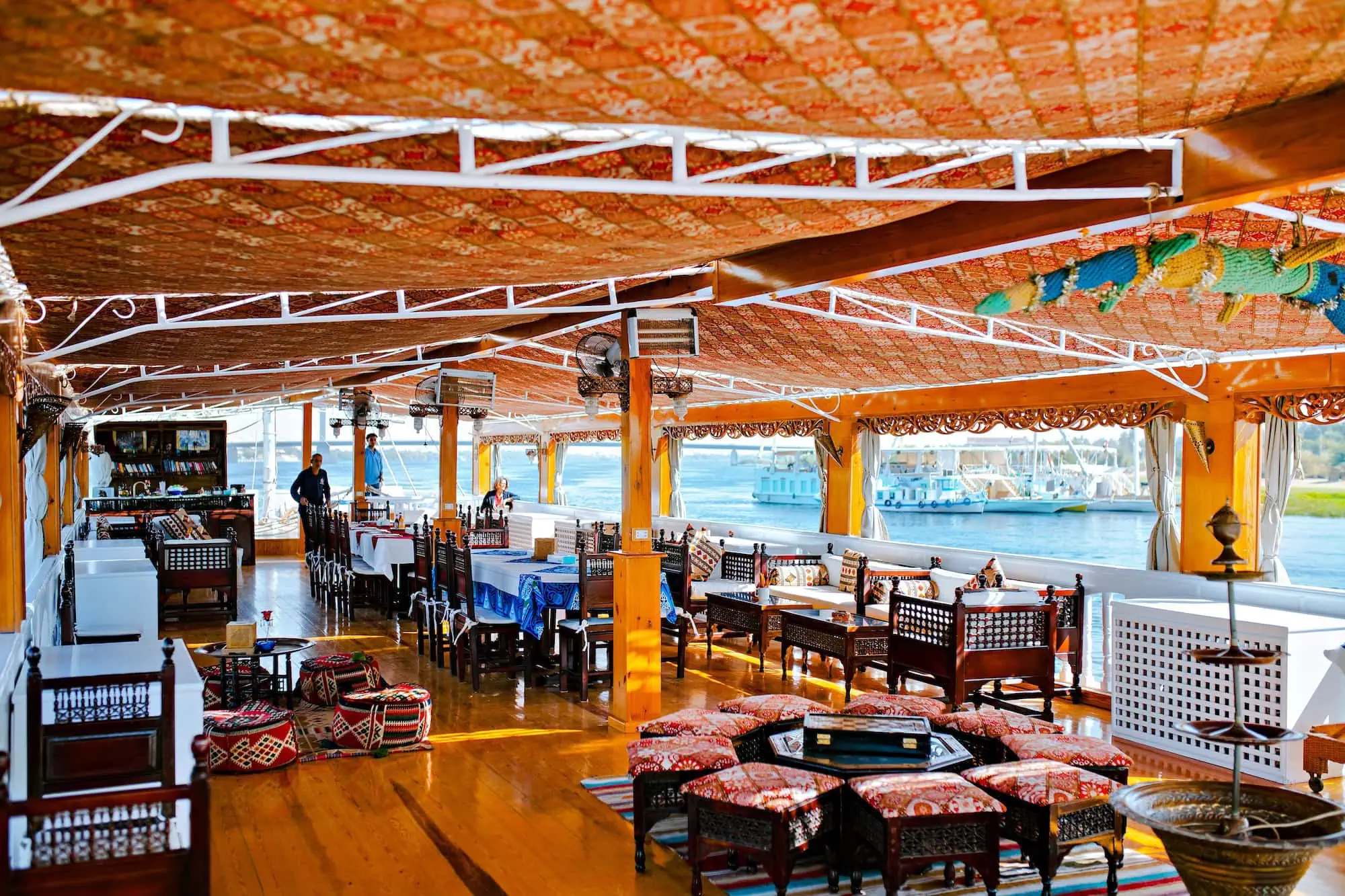 Luxurious Nile cruise boat dining area with ornate furniture and river views