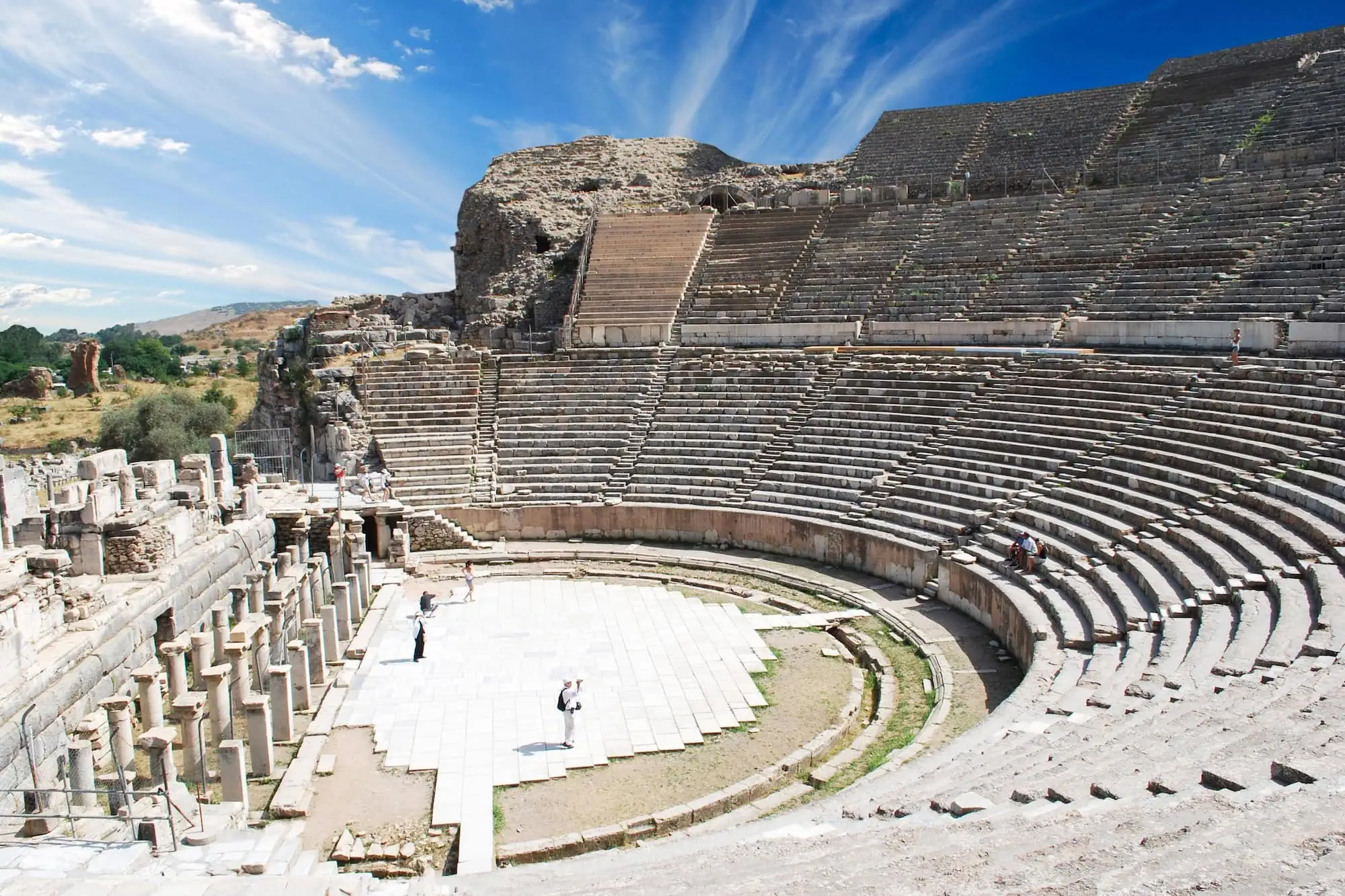 Ancient Roman amphitheater ruins at Ephesus showing stone seating tiers and performance area