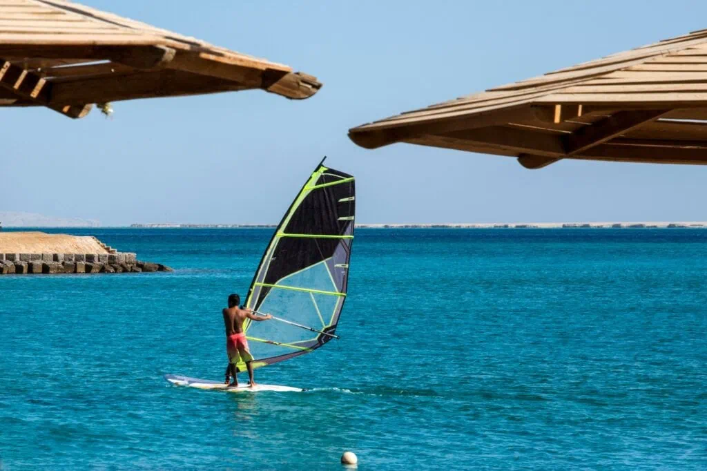 Surfer riding a surfboard on the Red Sea waters, Hurghada