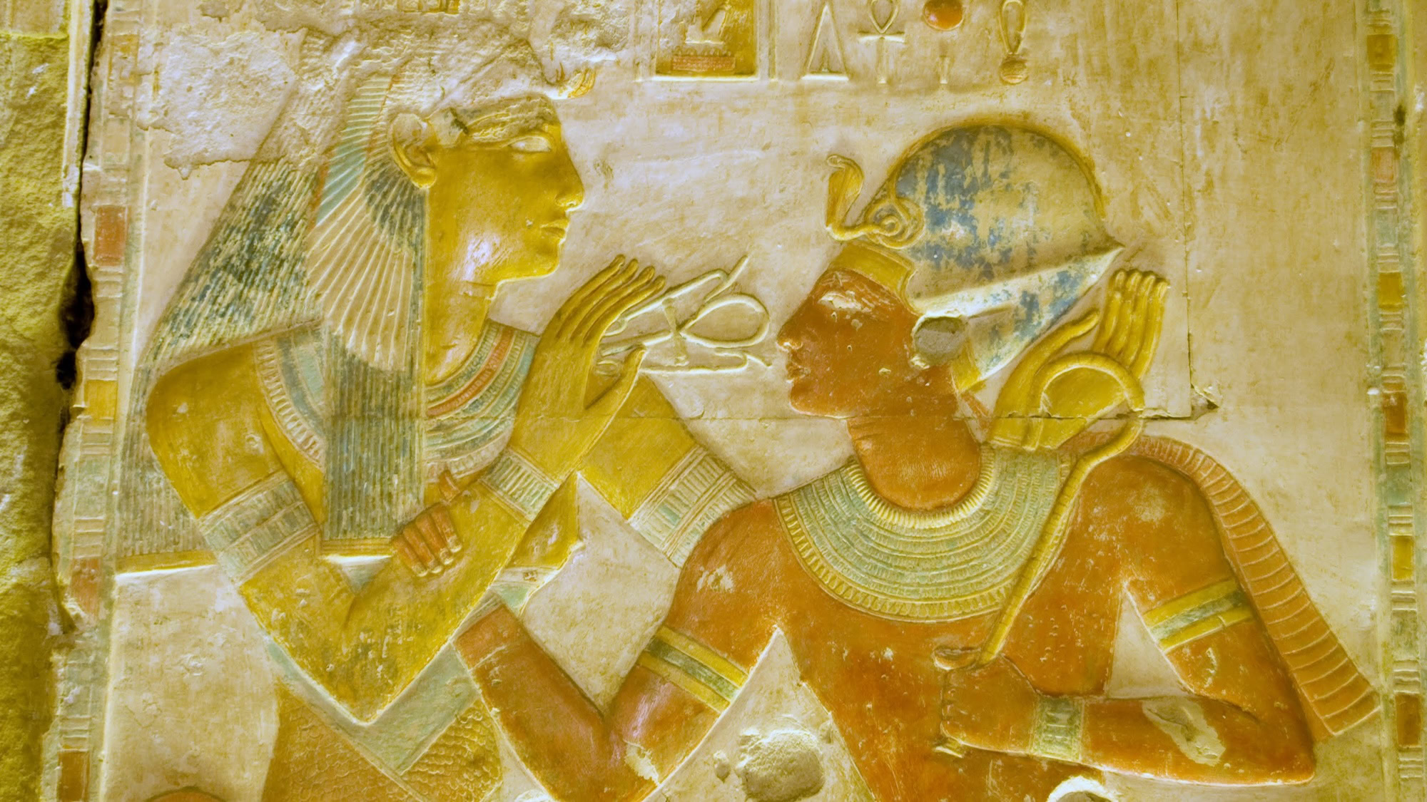 Ancient Egyptian tomb wall painting depicting pharaoh with deities, hieroglyphs, and ceremonial religious artwork