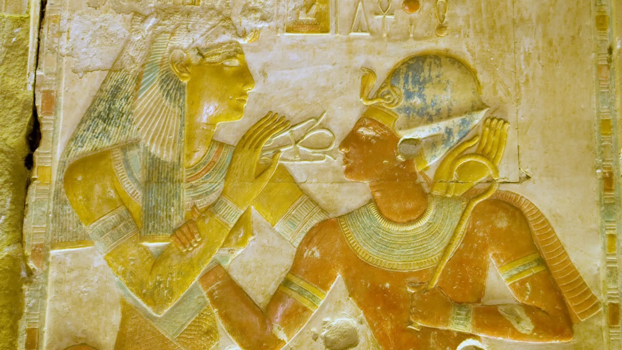 Ancient Egyptian tomb wall painting depicting pharaoh with deities, hieroglyphs, and ceremonial religious artwork