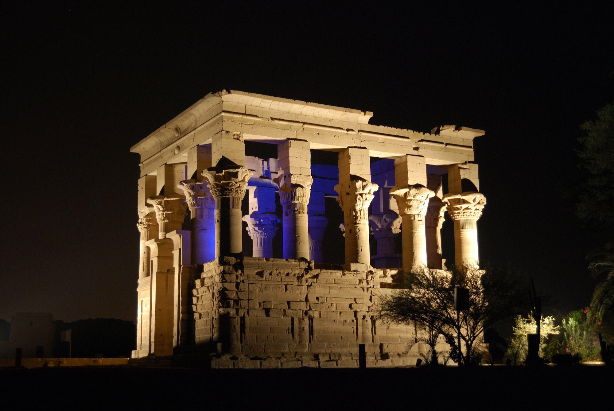 Philae Temple illuminated at night with columns and ancient stone architecture