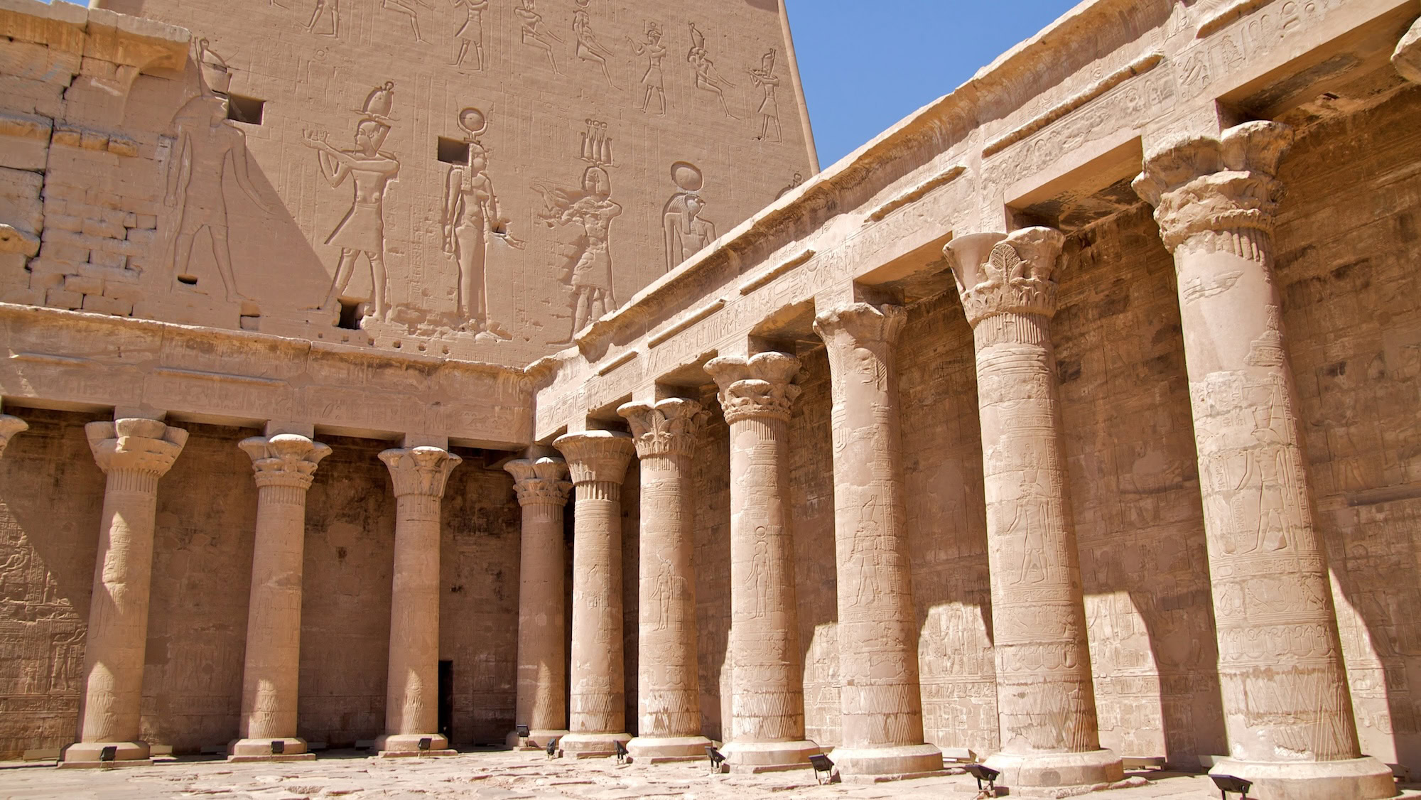 Hieroglyphic wall reliefs showing ancient Egyptian mythological figures at Edfu Temple