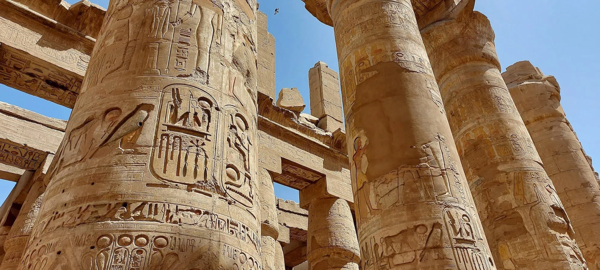 Ancient columns with hieroglyphs and stone carvings at Karnak Temple Complex, Egypt