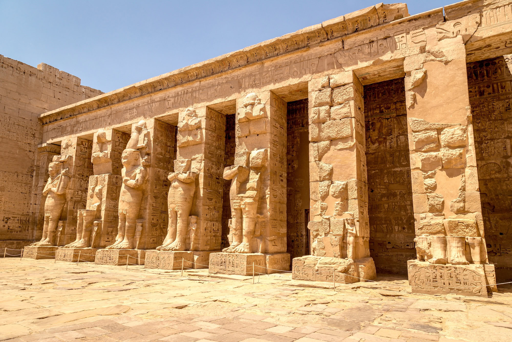 Ancient Egyptian temple with pharaoh statues and columns representing Egyptian governmental authority