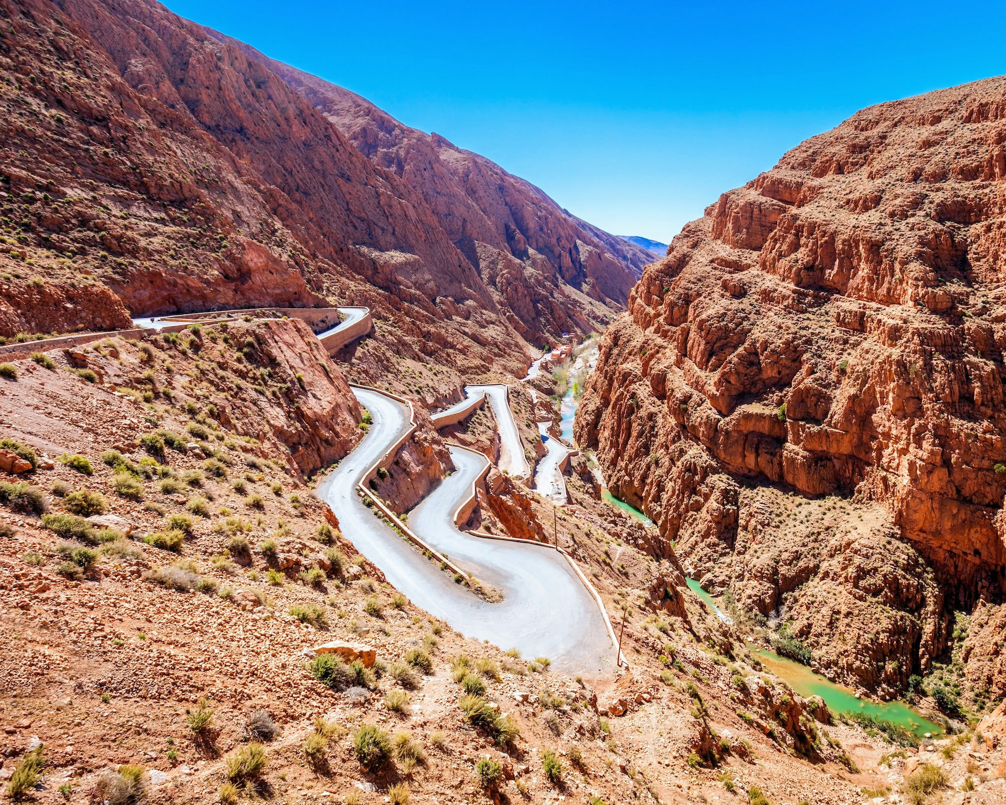 Dramatic winding road through Dades Gorge canyon with serpentine curves and towering rock formations