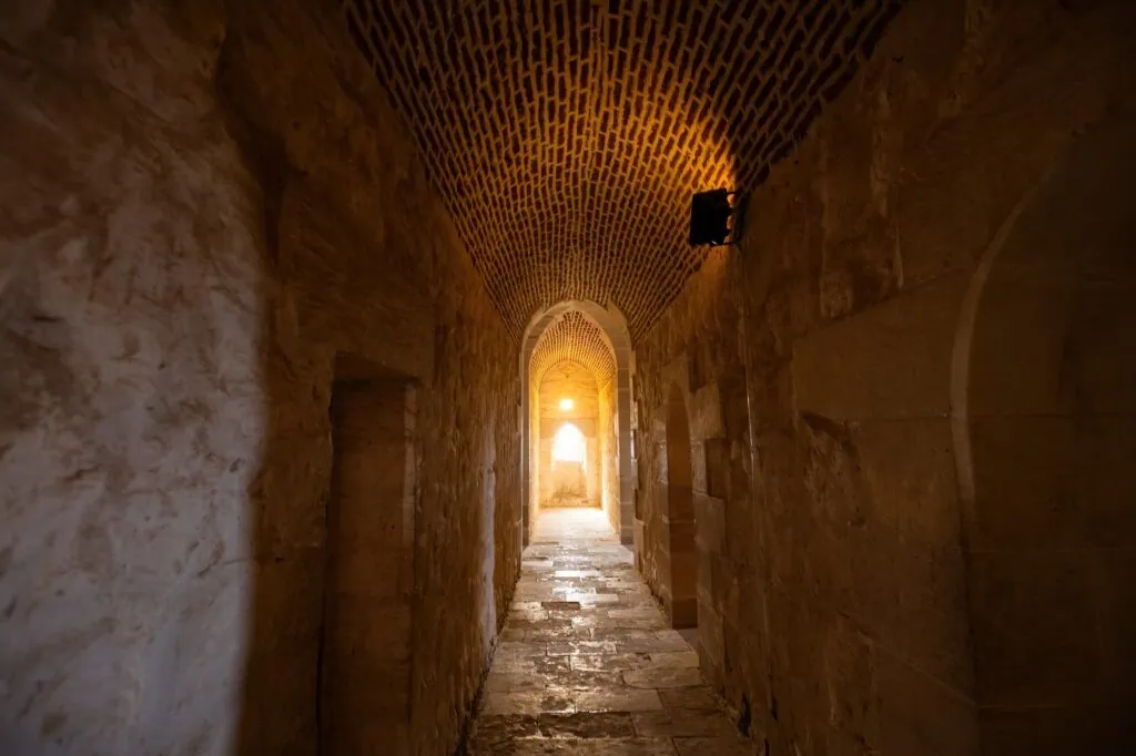 Narrow stone passageway showing architectural details and textured walls inside the Citadel of Qaitbay, Alexandria