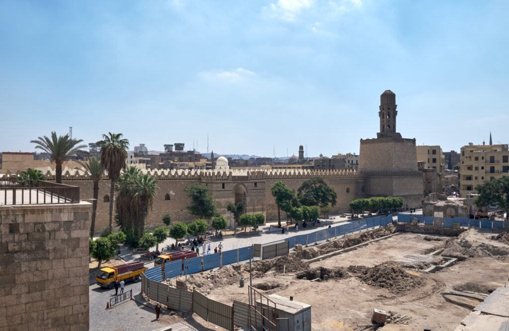 View of Bab al-Futuh showing the massive stone gate and round defensive towers along Al-Muizz Street, Bab al-Futuh, Cairo