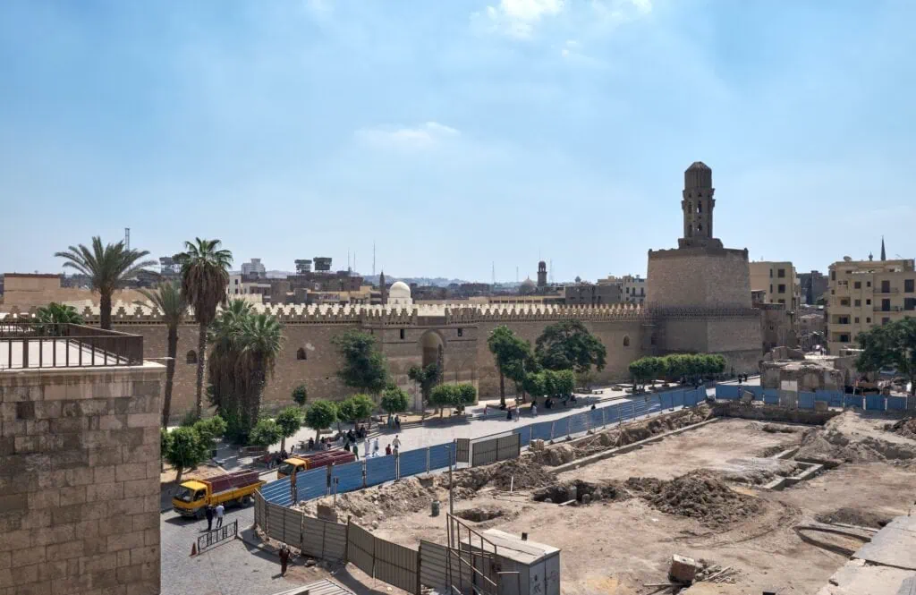 View of Bab al-Futuh showing the massive stone gate and round defensive towers along Al-Muizz Street, Bab al-Futuh, Cairo
