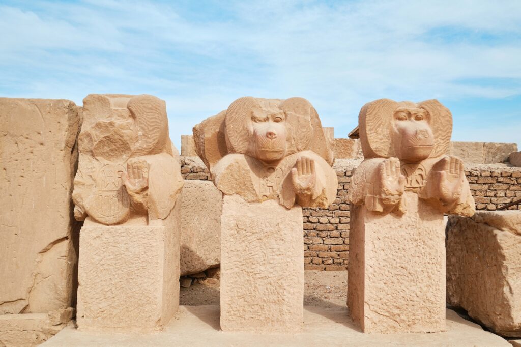 Baboon statues carved in stone positioned among temple ruins at the Ramesseum in the Theban Necropolis, Luxor
