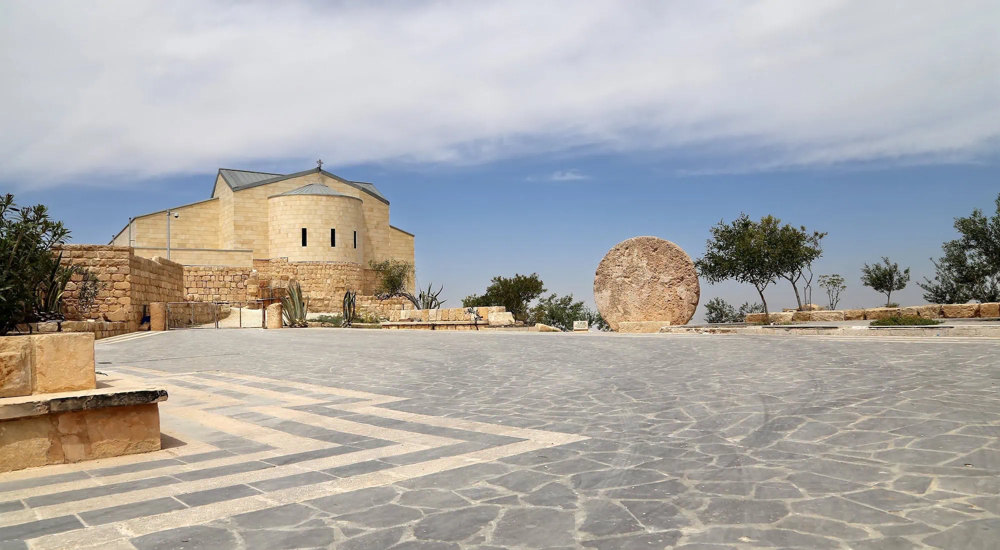 Modern stone basilica and archaeological ruins at Mount Nebo's Moses Memorial site in Jordan