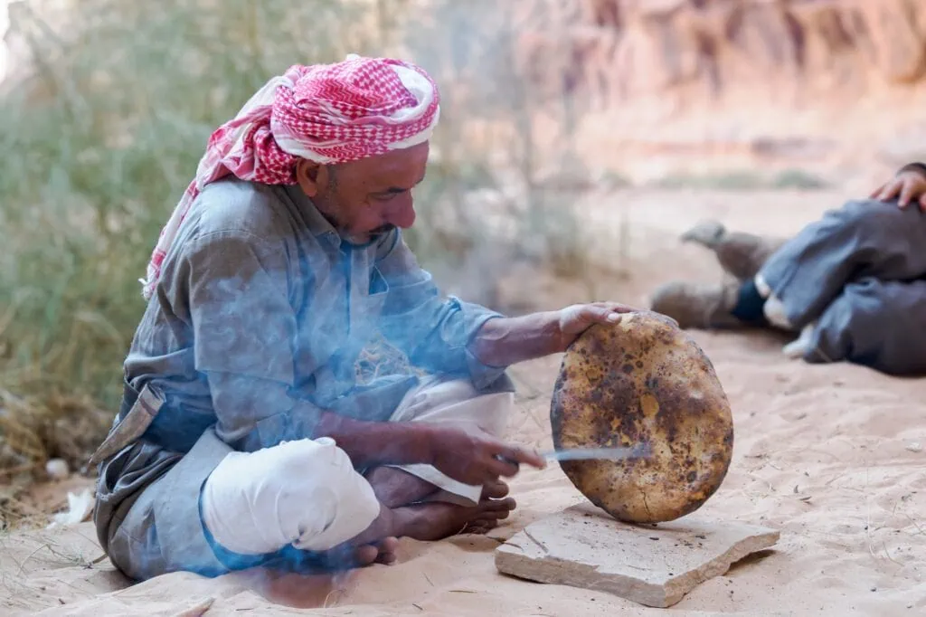 Bedouin makes Bedouin bread traditionally over a fire in the desert. Jordan