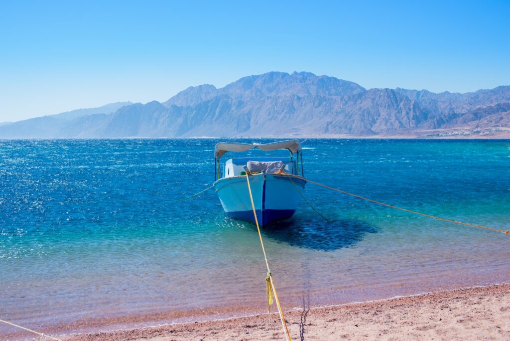Blue Lagoon with boat in Dahab Sinai Kite Lagoon of Dahab Egypt
